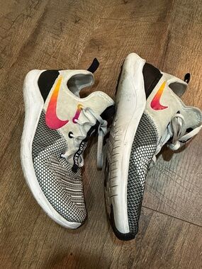 Nike White and Black Sneakers with Pink-Orange Swoosh
